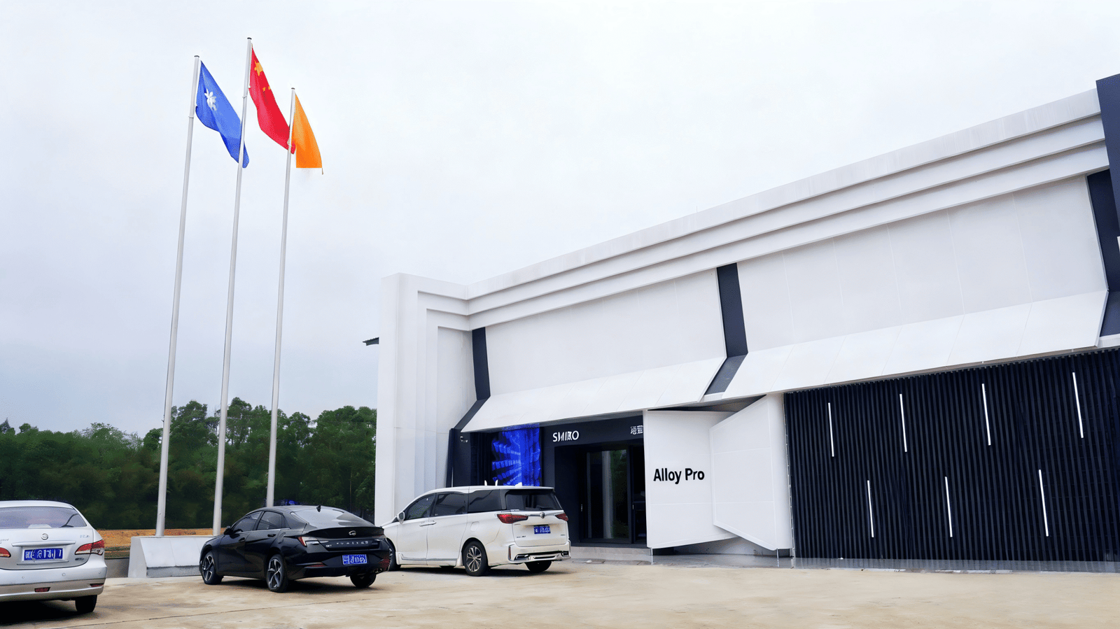 Alloy Pro factory front with flags and office building